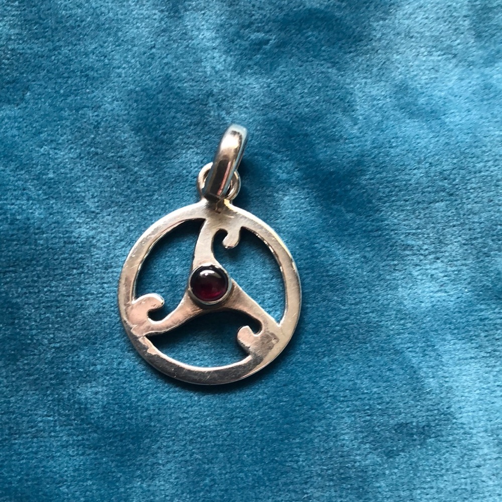 Triskele pendant with garnet gemstone